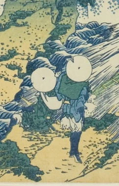 荷物を背負って歩く旅人