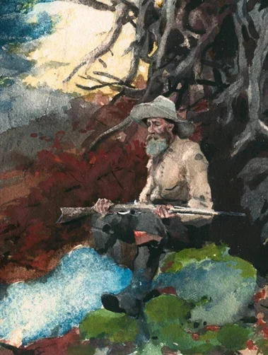 銃を持って座る男性