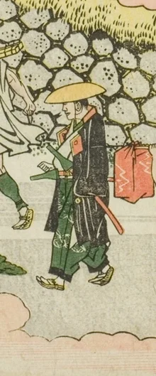 三度笠を被った旅人